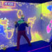 Three people, including one in a wheelchair, play on an interactive wall in an inclusive immersive room