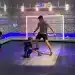Children and an adult playing football in front of an immersive interactive wall in a NeoXperiences playroom